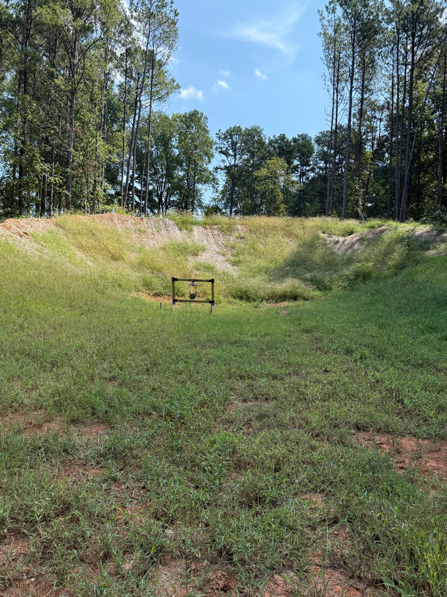 Steel gong target set against the backstop berm at the Fire Ammo testing range